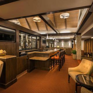 A stylish and modern bar interior with cozy seating and warm lighting.
