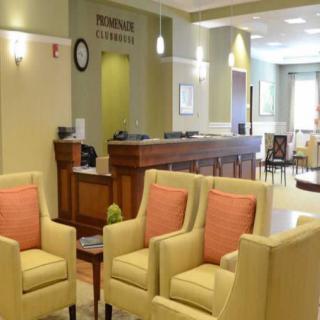 A well-lit lobby with comfortable seating and a reception desk.
