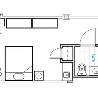 A floor plan of a studio apartment featuring a bedroom, bathroom, and kitchen area.