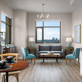 A modern living room with stylish furnishings and a scenic city view.