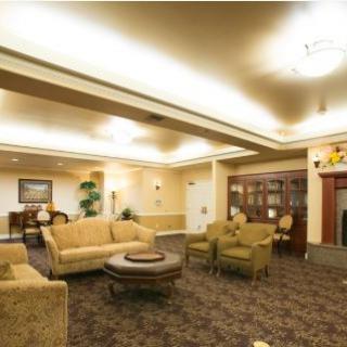 A spacious living room with comfortable seating and elegant lighting.