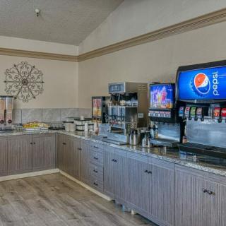 A self-serve beverage station with various drink options in a restaurant setting.