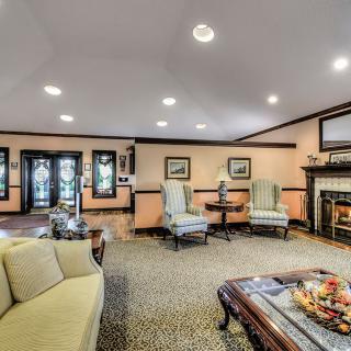 A cozy living room with elegant furniture and a warm fireplace.