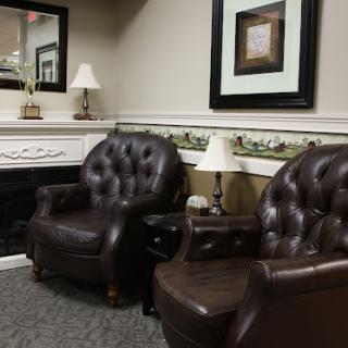 A cozy seating area featuring elegant brown leather chairs and tasteful decor.