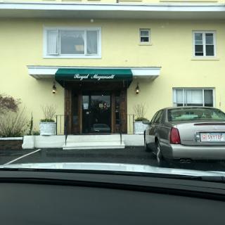 A view of the entrance to a yellow building with an awning.