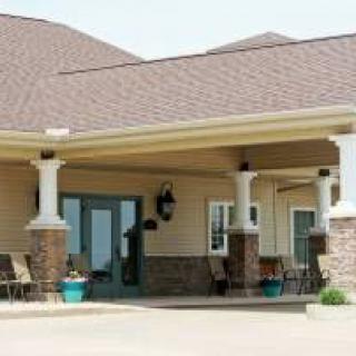 A building entrance with a covered porch and columns.