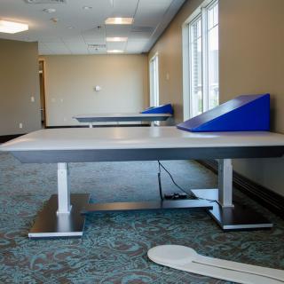 A therapy room with specialized tables and medical equipment.