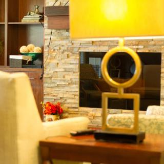 A stylish living room featuring a modern decorative sculpture, warm lighting, and a cozy ambiance.