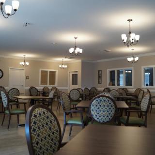 A spacious dining area with elegant furnishings and modern lighting.