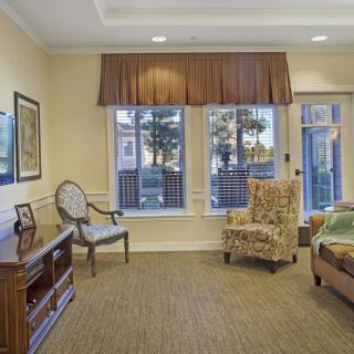 A cozy living room with comfortable seating and large windows allowing natural light.