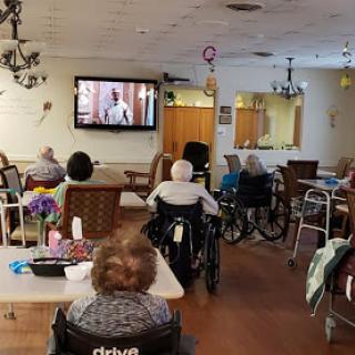 Residents of a care home enjoying a movie together.