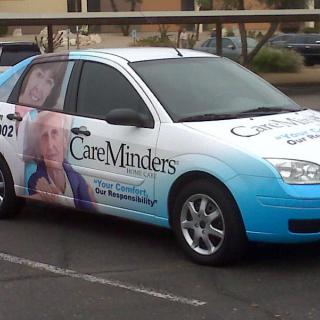 A car with CareMinders branding displaying healthcare services.