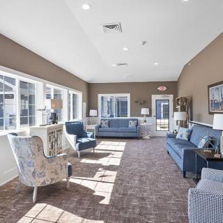 A bright living room with modern furniture and large windows.
