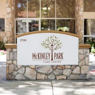 A stone sign with 'McKinley Park' displayed at the entrance of a building.