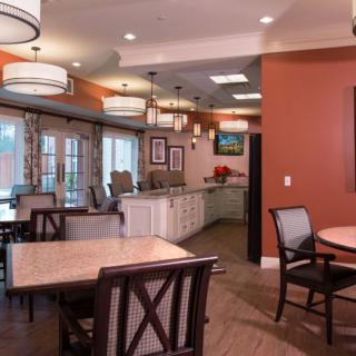 A modern dining room interior with elegant lighting and stylish furniture.