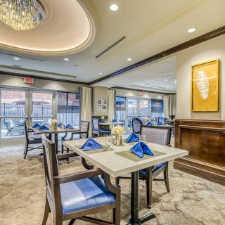 A modern and elegant restaurant dining area with neatly set tables and stylish decor.