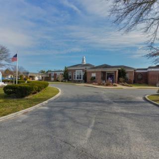 A view of the entrance to a community building on a clear day.