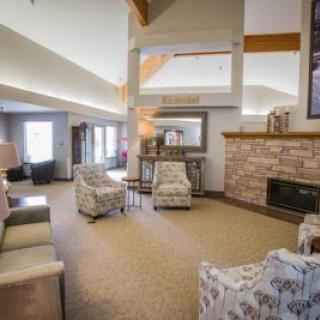 A cozy living room with modern decor, featuring comfortable seating and a fireplace.