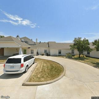 A suburban driveway with a parked car under a clear sky.