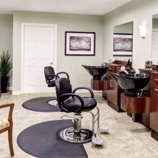A modern hair salon interior with chairs and mirrors.