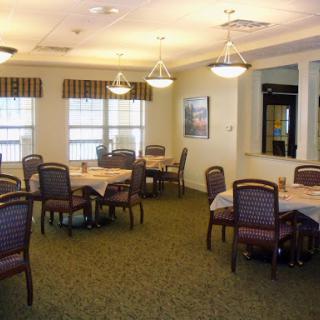 A cozy dining area set for a meal, featuring tables and chairs arranged in an inviting layout.