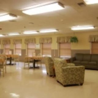 A spacious indoor lounge with comfortable seating and tables.