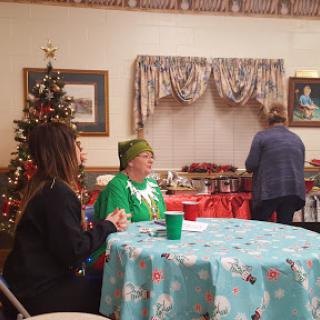 A cozy holiday gathering with decorations and festive outfits.