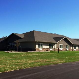 A suburban residential building with a neatly maintained lawn on a sunny day.