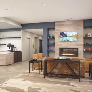A modern living room with a central fireplace, television, and stylish furniture.