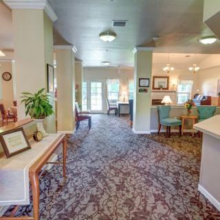 A cozy lobby area with plush carpeting, comfortable seating, and soft lighting.