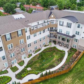 Aerial view of a residential apartment complex with landscaped gardens.