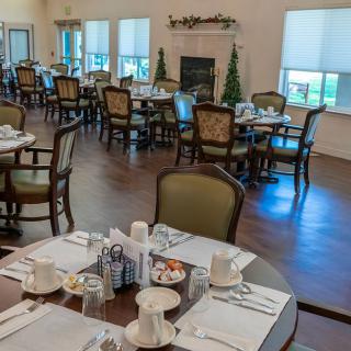 A well-decorated dining room with neatly arranged tables and chairs.