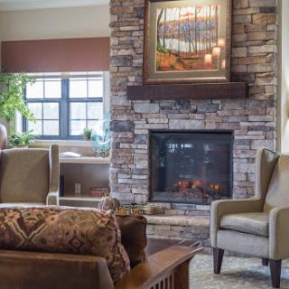 A cozy living room featuring a modern fireplace and stylish seating.