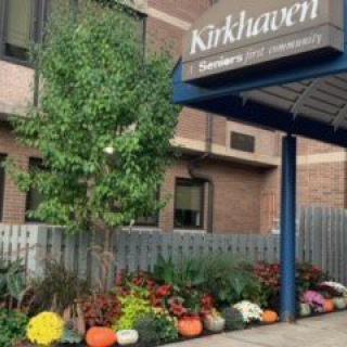 A welcoming entrance with a garden and sign at Kirkhaven.