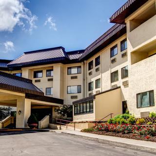 A modern hotel building with a welcoming entrance and landscaped surroundings.