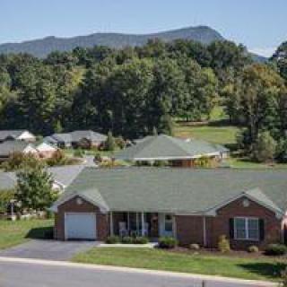 A suburban house with a mountainous landscape in the background.