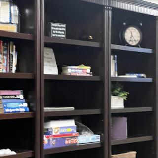 A neatly organized bookshelf featuring a mix of books and decorative items.