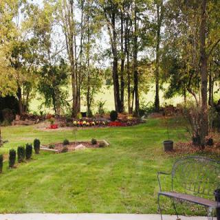 A peaceful cemetery surrounded by trees and greenery.