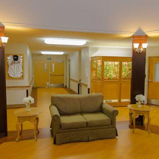A cozy lobby area featuring a comfortable couch and warm lighting, inviting relaxation in a welcoming environment.