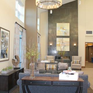 A modern lounge area featuring stylish furniture, decorative elements, and contemporary artwork.