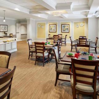 A well-lit dining area with neatly arranged tables and chairs in a stylish setting.