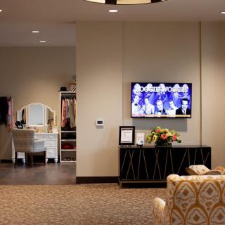 A cozy living room with a TV, vanity, and decorative elements.