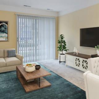 A modern living room with a sofa, coffee table, TV, and stylish decor.