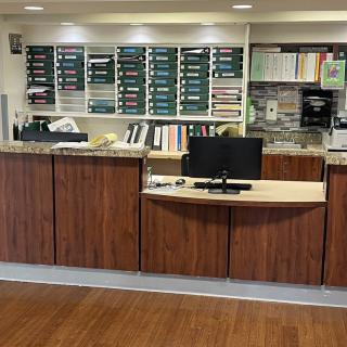 A reception desk with office equipment and organized workspace.