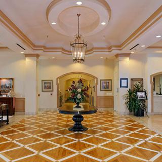 A luxurious lobby with elegant chandeliers and intricate flooring.