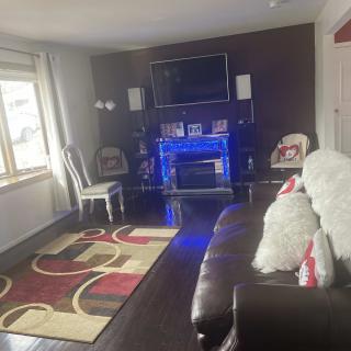 A cozy living room with a fireplace, television, and comfortable seating.