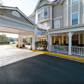 A hotel entrance with a covered driveway and stylish architecture.
