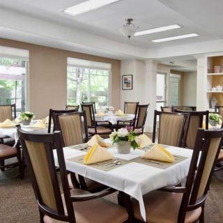 A well-arranged dining area with elegant table settings and comfortable chairs.