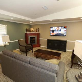 Modern living room with a comfortable sofa, fireplace, and a wall-mounted television.