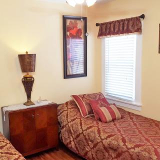 A cozy bedroom with twin beds and decorative elements.